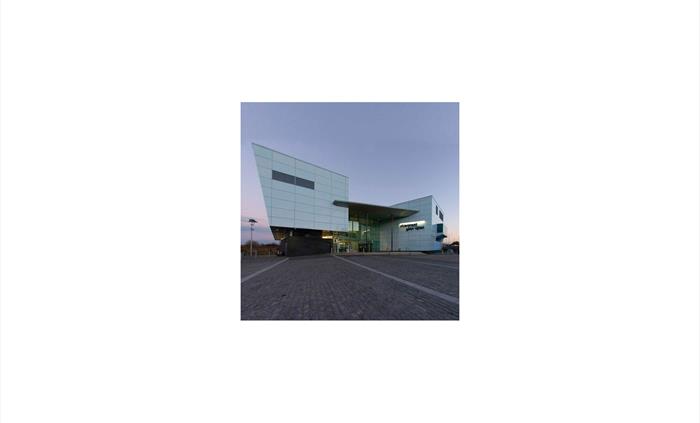 The outside of a blue theatre building.